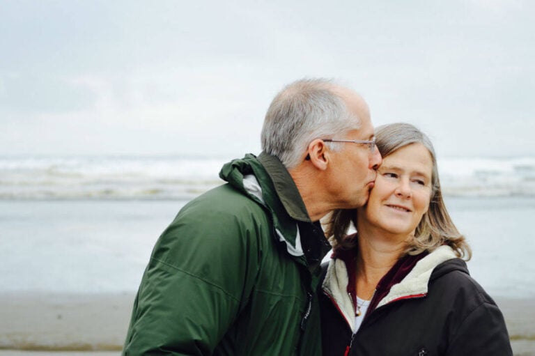 man kissing his wife on the cheek