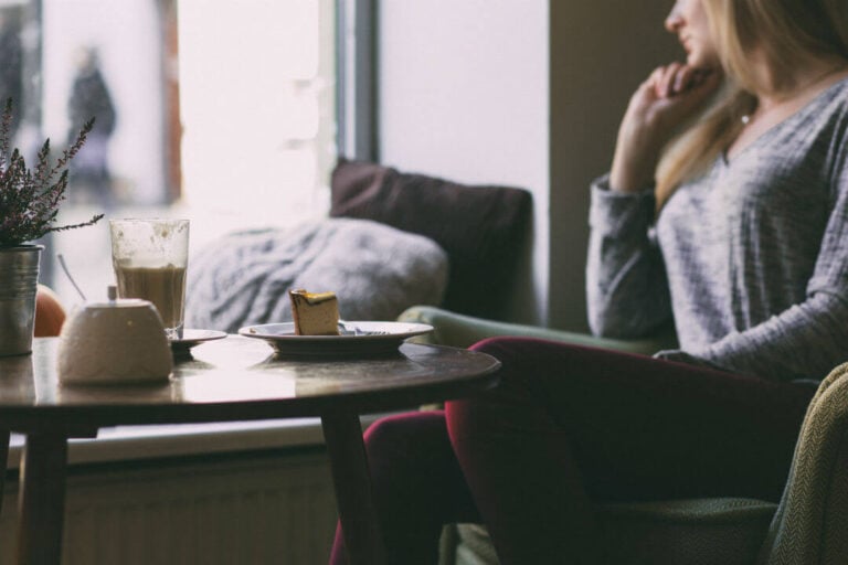 woman sitting and contemplating in a cafe
