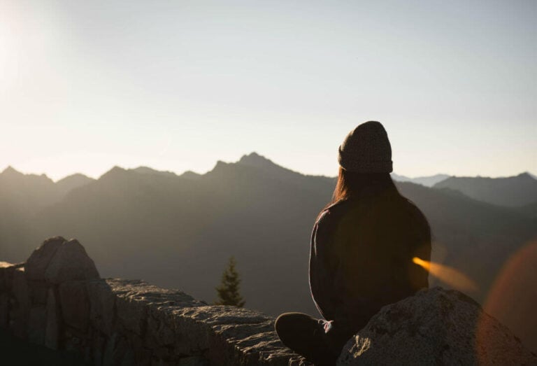 woman on mountain meditating